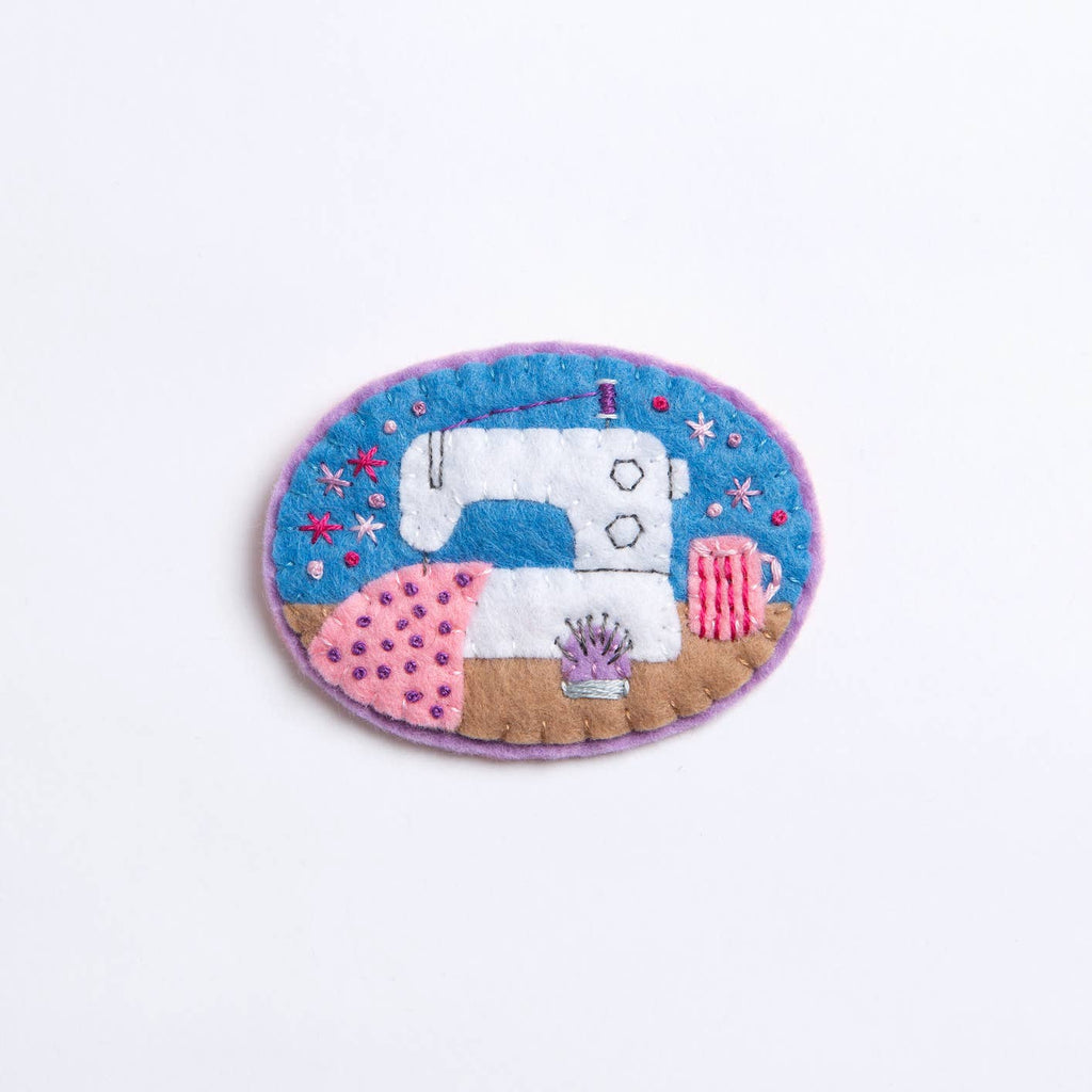 Embroidered patch of a sewing machine on a white background
