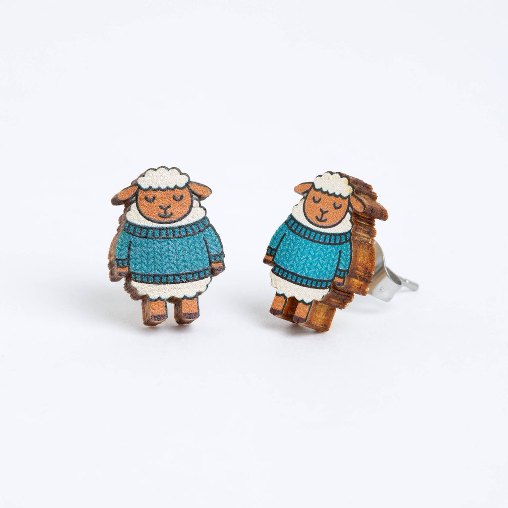 Sheep-shaped earrings with blue sweaters on a white background