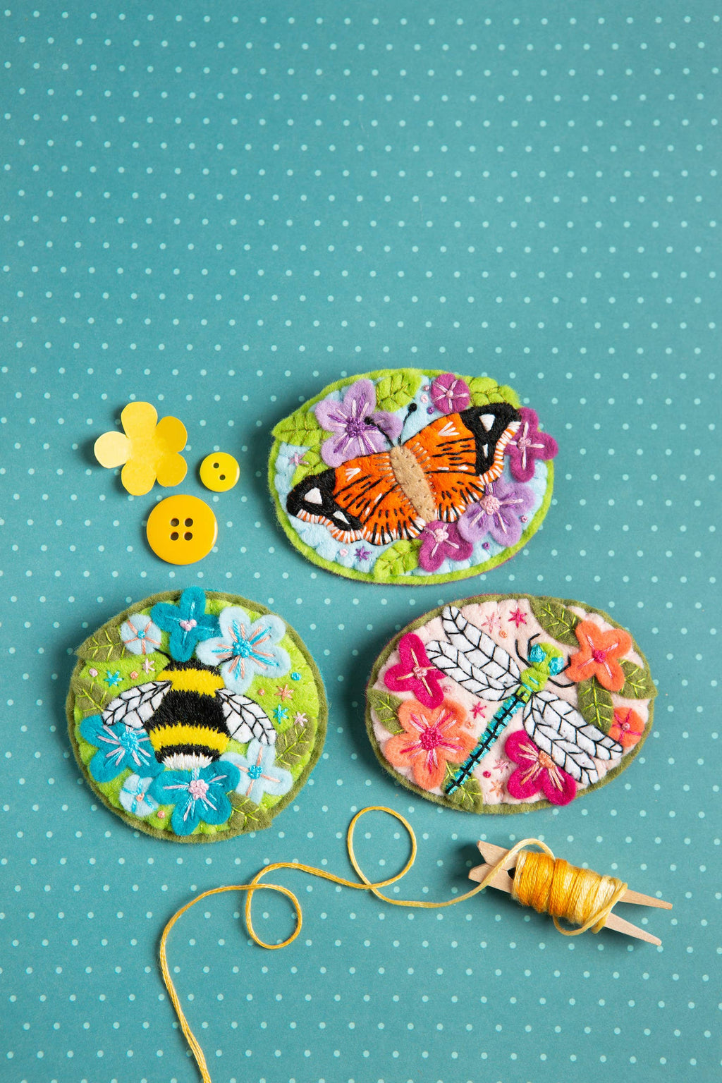 Decorative buttons with floral and insect designs on a polka dot background