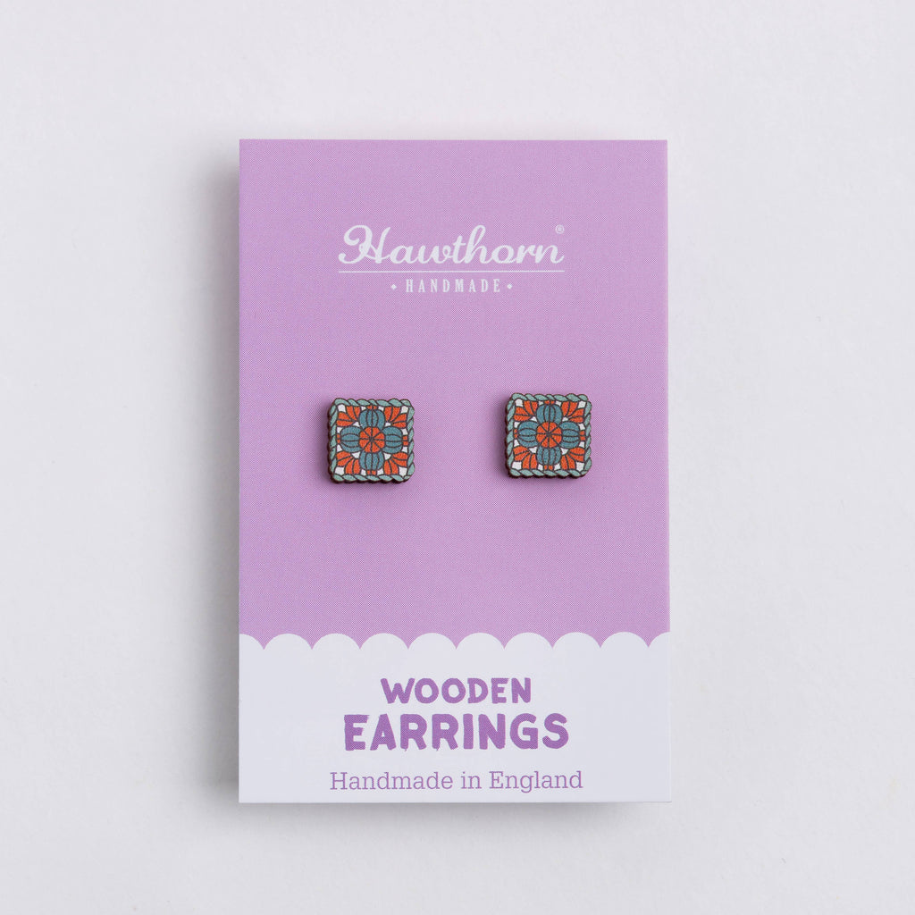 Wooden earrings on a Hawthorn Handmade card with a purple background