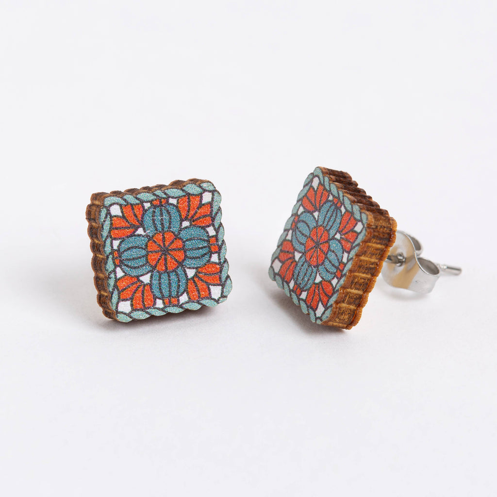 Square floral patterned earrings on a white background