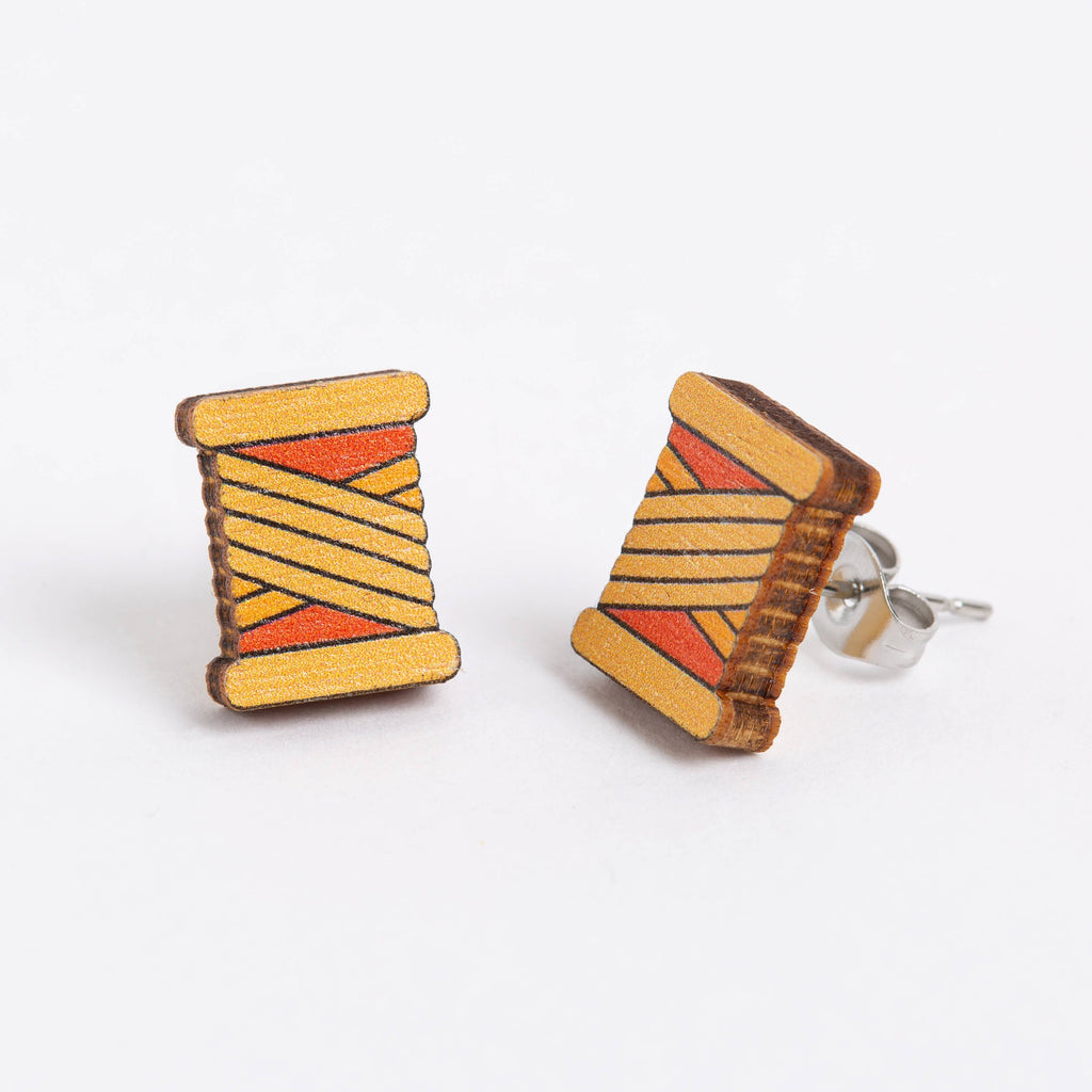 Hawthorn Handmade orange bobbin earrings white bgd