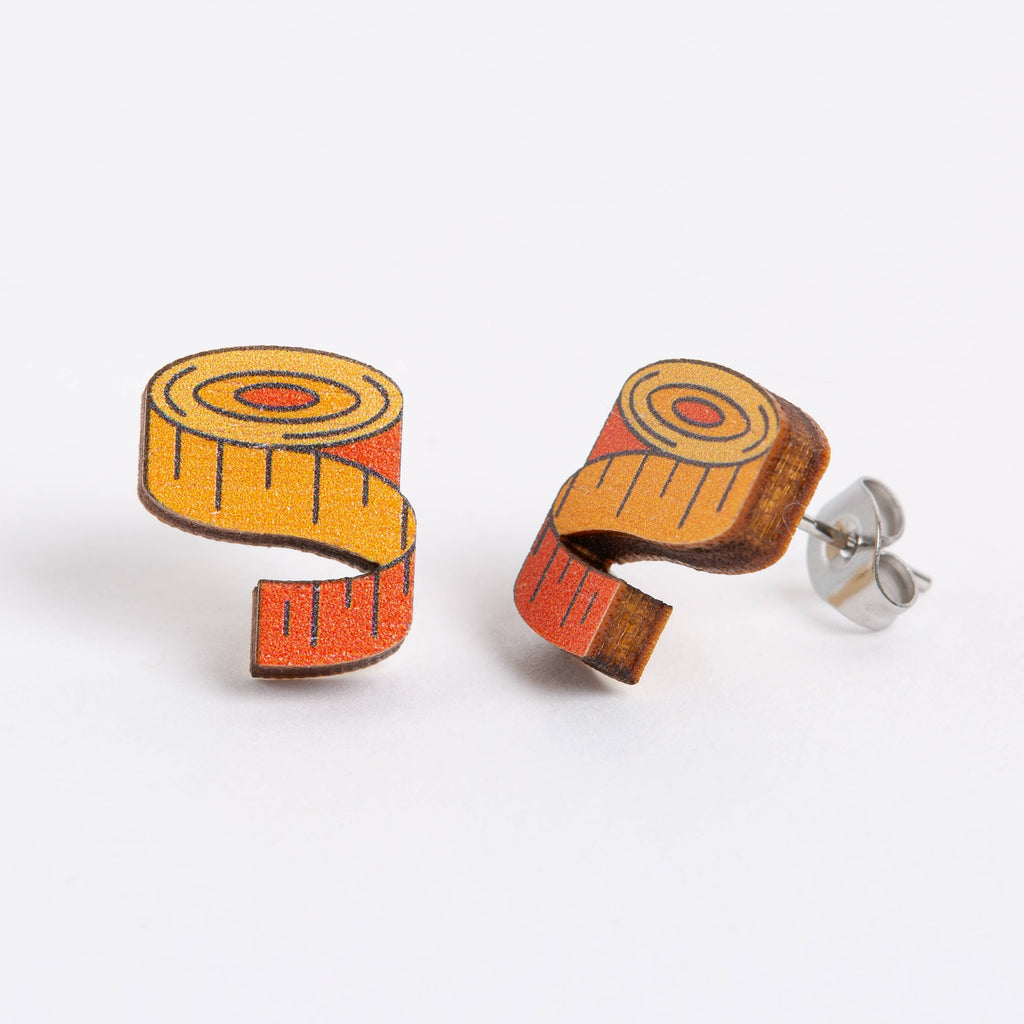 Wooden tape measure earrings on a white background
