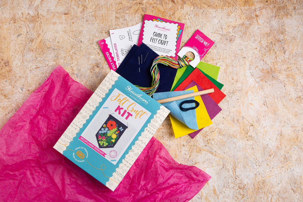 Craft kit with colorful materials on a textured surface