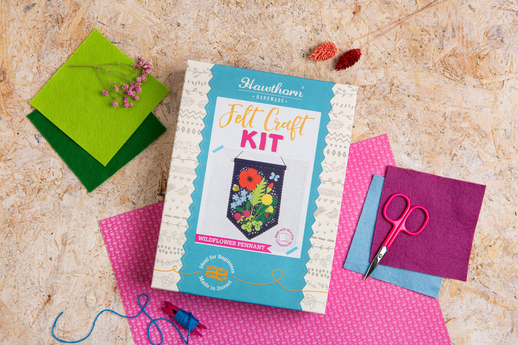 Felt craft kit with materials on a textured surface