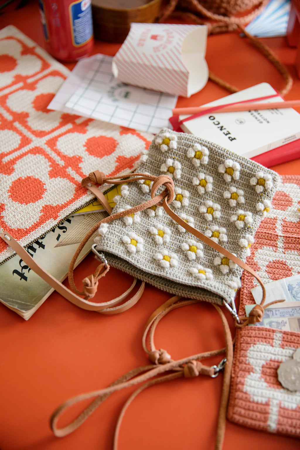 Crochet bag with floral pattern on an orange surface